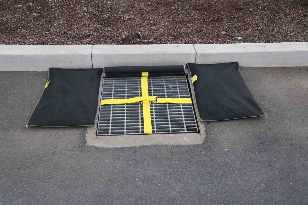 Gravel bags being used perimeter control around a storm drain.